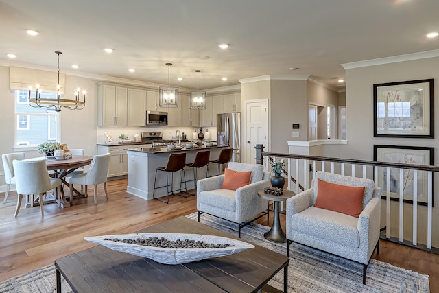 4187 Chelsea Manor Cir, Aurora, IL 60504 - living area with ornamental molding, recessed lighting, an inviting chandelier, and light wood-style flooring