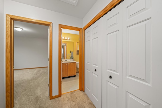 471 W Miller Ave, Hinckley, IL 60520 - corridor featuring light colored carpet, baseboards, and a sink