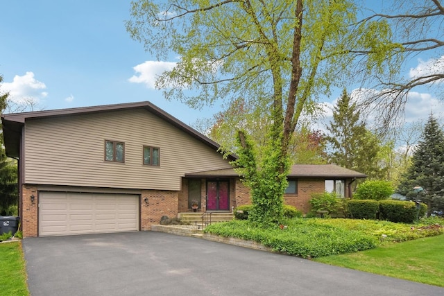 38413 N Tewes Ct, Beach Park, IL 60087 - split level home featuring brick siding, an attached garage, and asphalt driveway