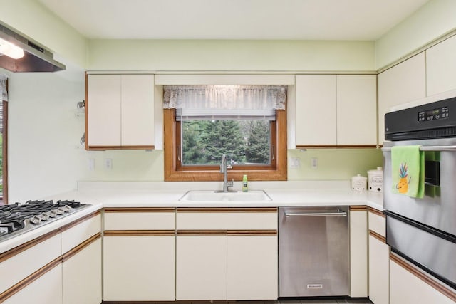 38413 N Tewes Ct, Beach Park, IL 60087 - kitchen featuring stainless steel appliances, a sink, a warming drawer, under cabinet range hood, and light countertops
