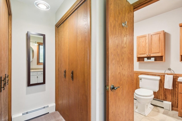 38413 N Tewes Ct, Beach Park, IL 60087 - bathroom featuring a baseboard heating unit, toilet, wainscoting, and tile patterned flooring