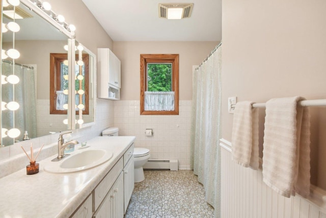 38413 N Tewes Ct, Beach Park, IL 60087 - bathroom featuring a baseboard heating unit, toilet, vanity, wainscoting, and tile patterned floors