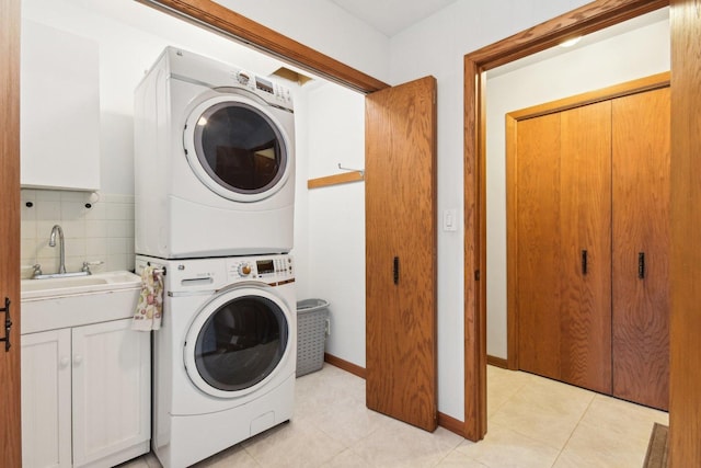 38413 N Tewes Ct, Beach Park, IL 60087 - washroom featuring stacked washer / dryer, light tile patterned floors, baseboards, and cabinet space