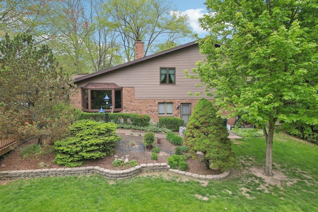 38413 N Tewes Ct, Beach Park, IL 60087 - view of front facade with a front lawn, a chimney, and brick siding