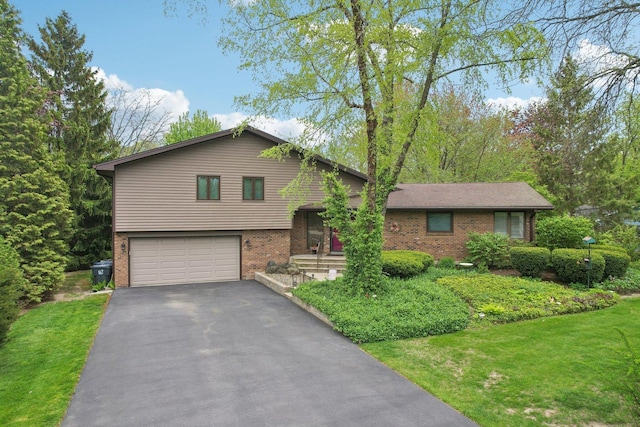 38413 N Tewes Ct, Beach Park, IL 60087 - tri-level home featuring brick siding, an attached garage, asphalt driveway, and a front yard