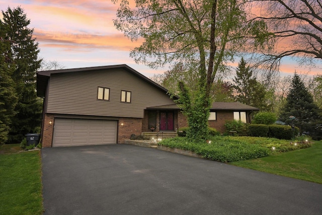 38413 N Tewes Ct, Beach Park, IL 60087 - tri-level home with brick siding, a garage, and asphalt driveway