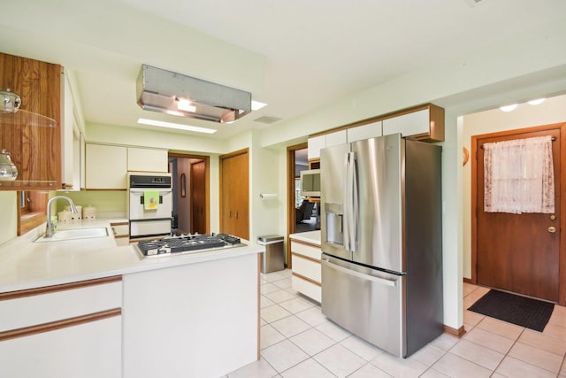 38413 N Tewes Ct, Beach Park, IL 60087 - kitchen featuring appliances with stainless steel finishes, a sink, light countertops, and light tile patterned floors