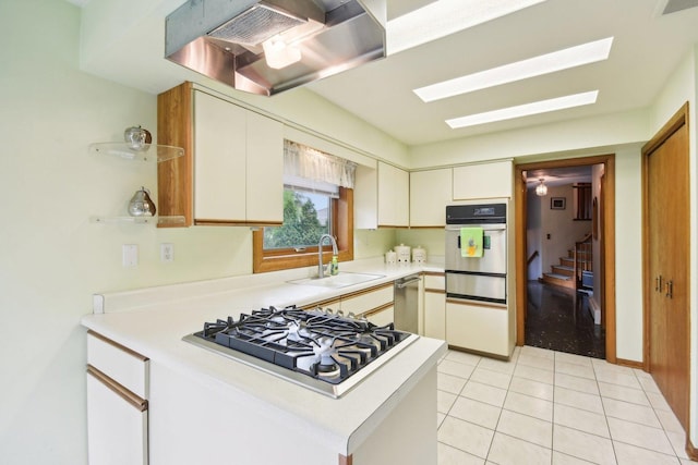 38413 N Tewes Ct, Beach Park, IL 60087 - kitchen featuring stainless steel appliances, wall chimney range hood, a sink, a warming drawer, and light countertops
