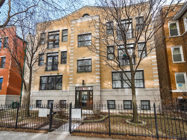 view of apartment building / complex with a fenced front yard