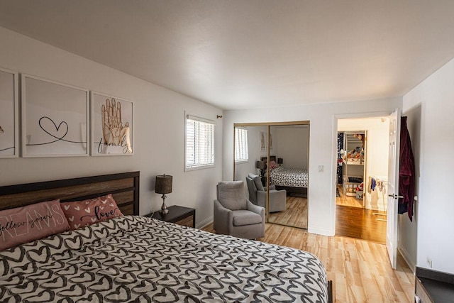 bedroom with baseboards, a closet, and light wood-style flooring