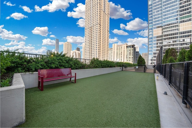 view of property's community with a view of city and fence
