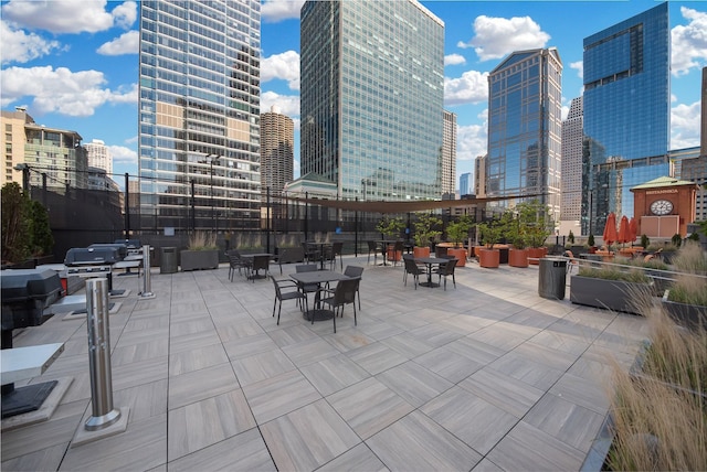 view of patio / terrace with area for grilling and a view of city
