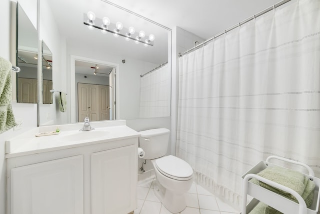 full bathroom with tile patterned floors, vanity, toilet, and curtained shower