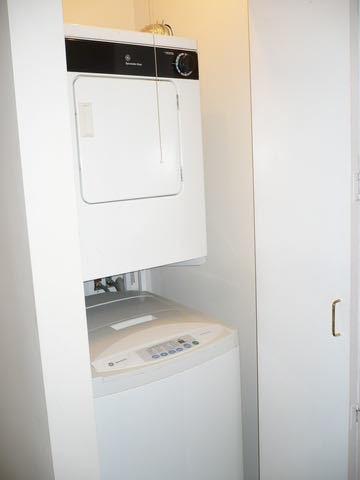laundry room featuring laundry area and stacked washer / dryer