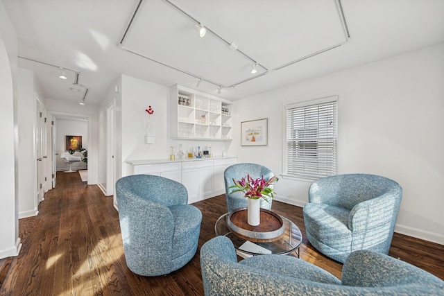 sitting room featuring dark wood-style floors, track lighting, a dry bar, and attic access