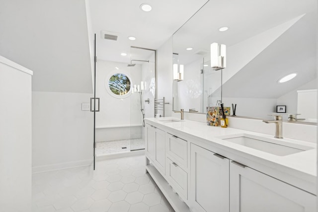 full bath with visible vents, a sink, and a shower stall
