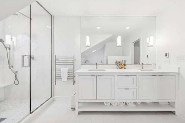 bathroom featuring a sink, tile patterned floors, and a shower stall