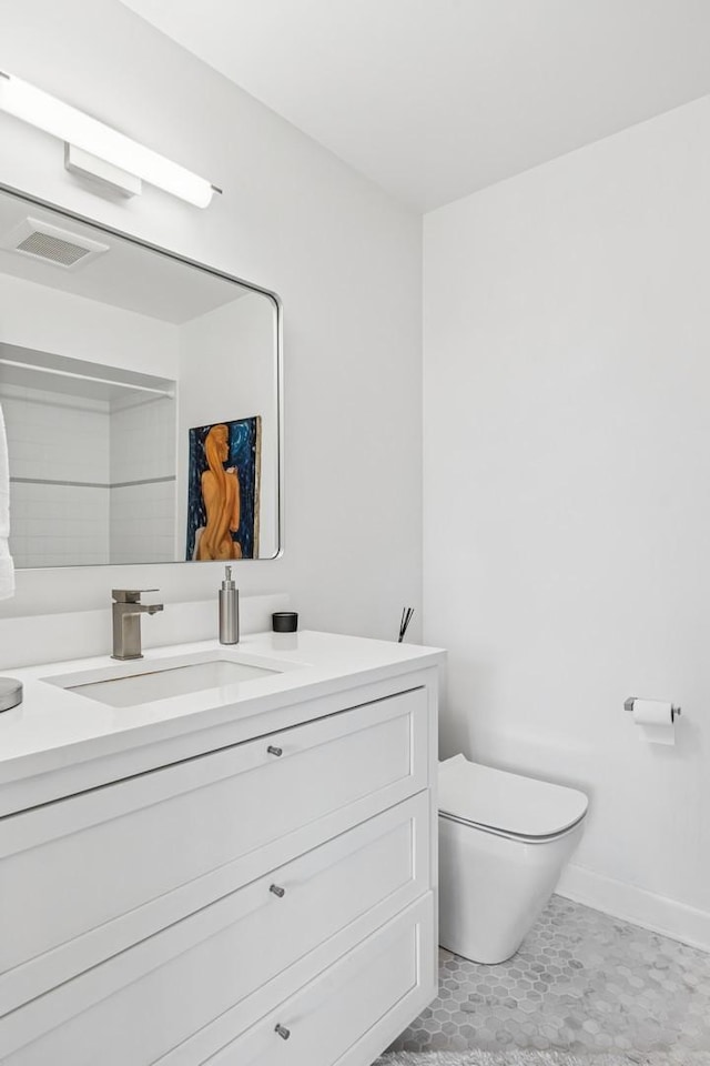 bathroom featuring vanity, baseboards, toilet, and visible vents