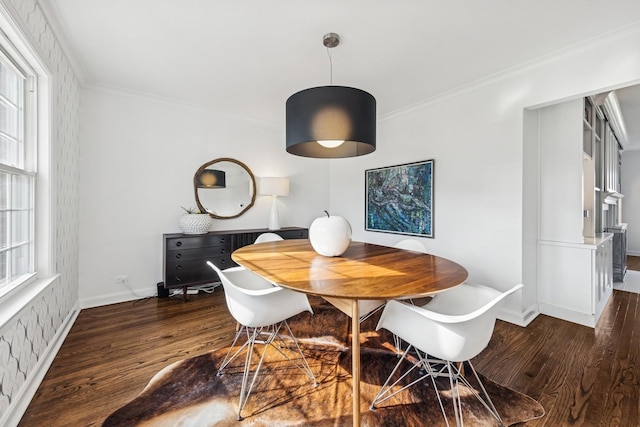 dining room featuring baseboards, ornamental molding, and wood finished floors