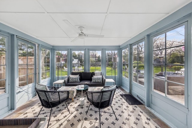 sunroom / solarium with a ceiling fan and outdoor lounge area