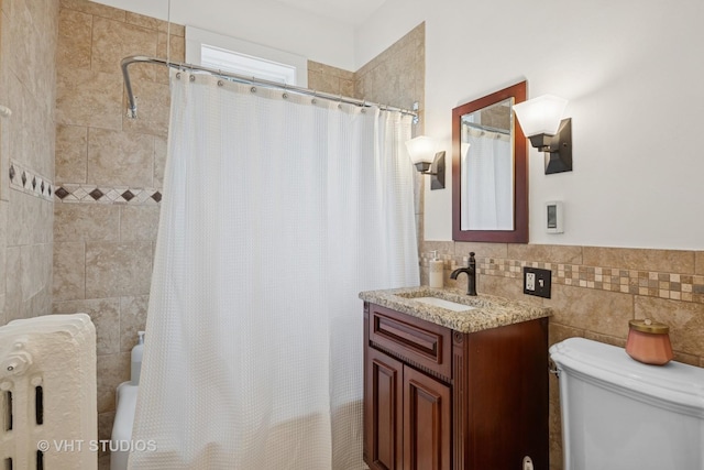 1625 Central Ave, Wilmette, IL 60091 - bathroom with shower / bath combo with shower curtain, vanity, toilet, tile walls, and a wainscoted wall