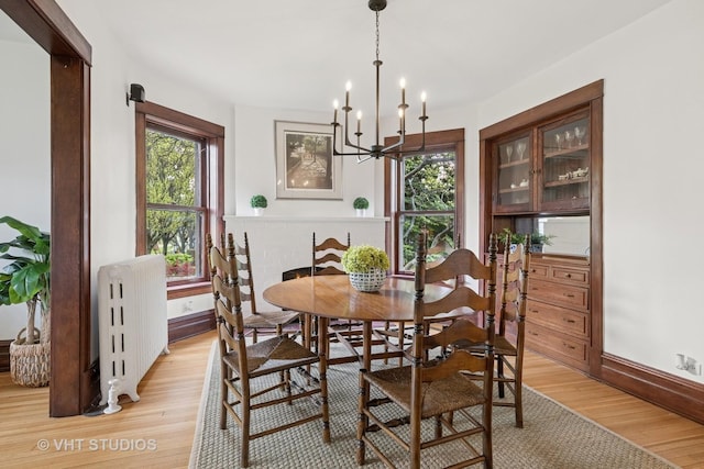 1625 Central Ave, Wilmette, IL 60091 - dining space featuring light wood-type flooring, radiator, baseboards, and an inviting chandelier
