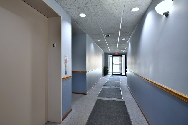 hallway featuring elevator, carpet, recessed lighting, baseboards, and a drop ceiling