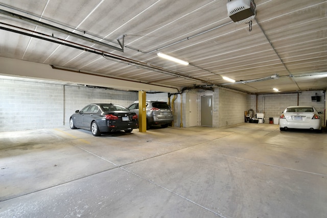 parking garage featuring a garage door opener