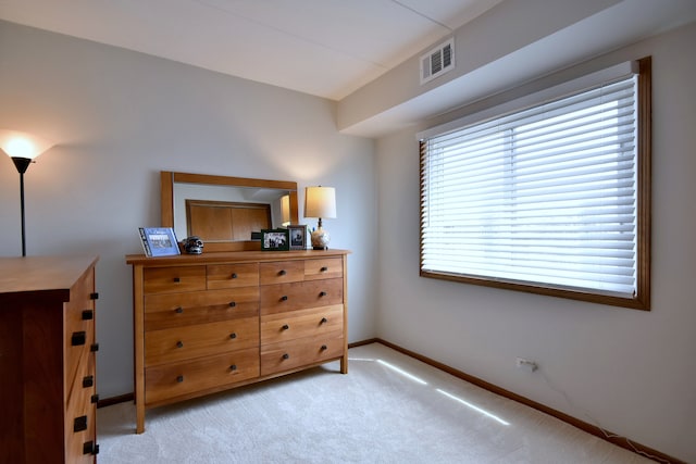 bedroom featuring light colored carpet, baseboards, and visible vents