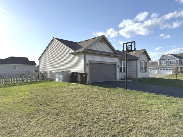 10817 Quail Xing, Richmond, IL 60071 - view of property exterior featuring fence, a yard, a garage, and aphalt driveway