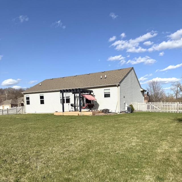 10817 Quail Xing, Richmond, IL 60071 - rear view of house with a patio, fence, roof with shingles, and a lawn