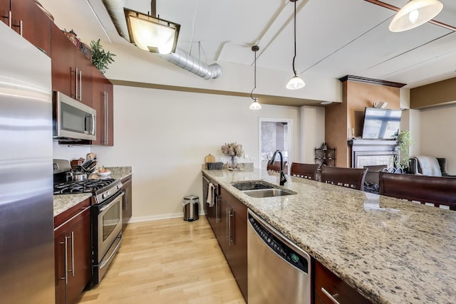 170 N NW Hwy Unit 410, Park Ridge, IL 60068 - kitchen with a sink, stainless steel appliances, decorative light fixtures, light wood-style flooring, and baseboards