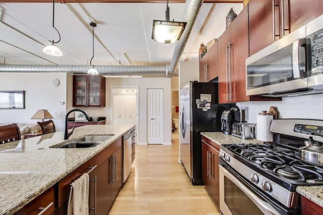 170 N NW Hwy Unit 410, Park Ridge, IL 60068 - kitchen featuring light stone countertops, a sink, stainless steel appliances, light wood-type flooring, and decorative light fixtures