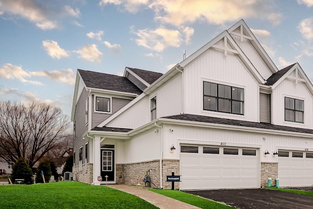 4314 Chelsea Manor Cir, Aurora, IL 60504 - view of front of house featuring a front lawn, driveway, an attached garage, and stone siding