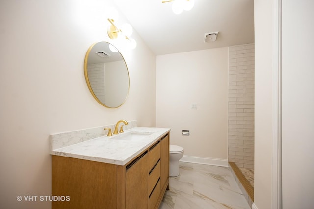 full bath with vanity, toilet, tiled shower, and marble finish floor