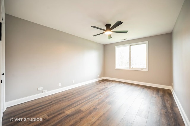 unfurnished room featuring baseboards, a ceiling fan, dark wood-style flooring, and visible vents