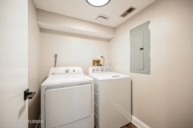 clothes washing area with laundry area, washer and dryer, electric panel, and visible vents