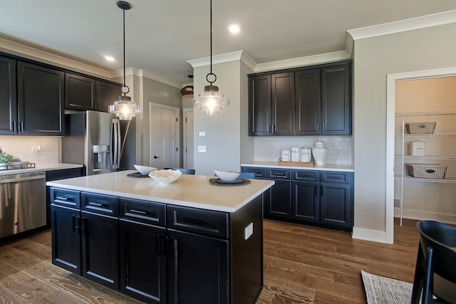 kitchen featuring dark wood-style floors, light countertops, stainless steel appliances, and tasteful backsplash