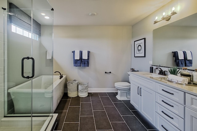 bathroom featuring a stall shower, vanity, and baseboards