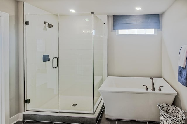 bathroom featuring recessed lighting, a freestanding bath, and a stall shower