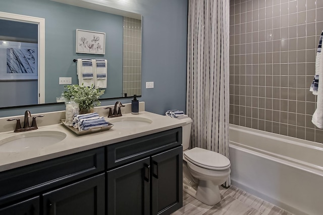 bathroom with toilet, double vanity, a sink, and shower / bathtub combination with curtain