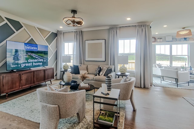 living room featuring wood finished floors, recessed lighting, and a notable chandelier