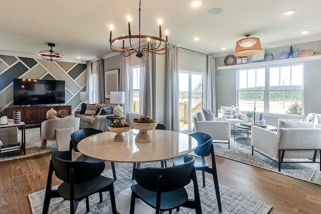dining room with dark wood-style floors, recessed lighting, and an inviting chandelier