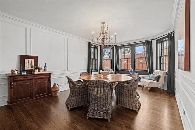1316 Maple Ave Unit B2, Evanston, IL 60201 - dining space featuring a chandelier, crown molding, dark wood finished floors, and a decorative wall