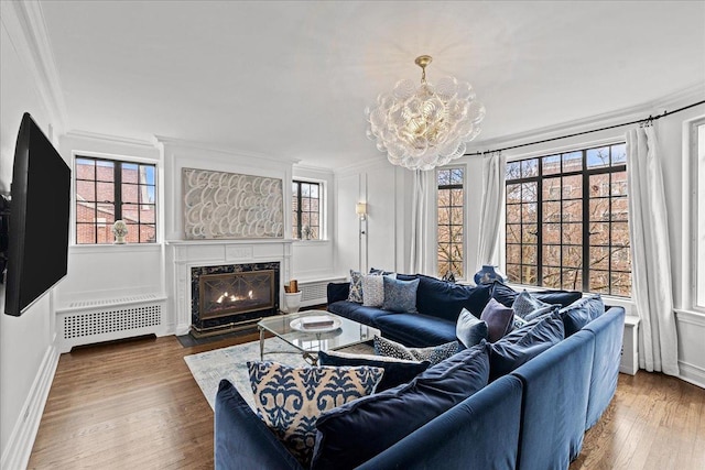 1316 Maple Ave Unit B2, Evanston, IL 60201 - living area featuring an inviting chandelier, wood finished floors, plenty of natural light, and ornamental molding