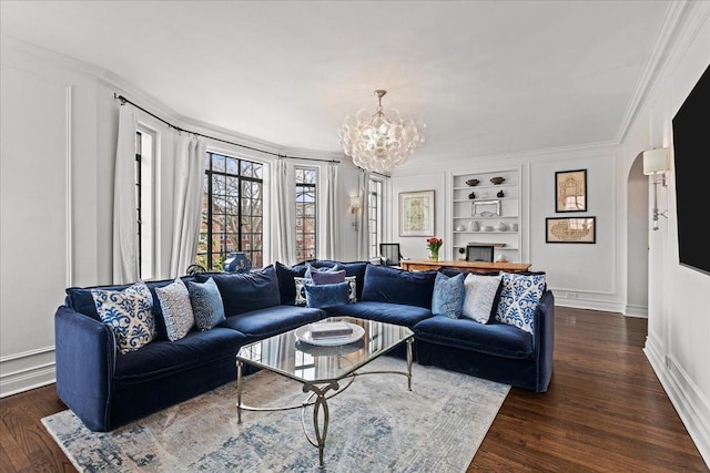 1316 Maple Ave Unit B2, Evanston, IL 60201 - living room featuring dark wood-type flooring, a chandelier, arched walkways, and built in shelves