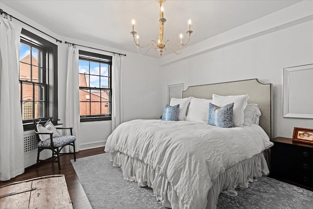 1316 Maple Ave Unit B2, Evanston, IL 60201 - bedroom featuring a notable chandelier, baseboards, and dark wood-type flooring