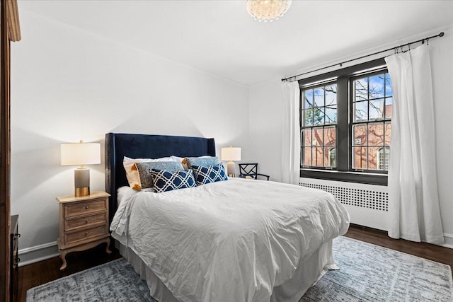 1316 Maple Ave Unit B2, Evanston, IL 60201 - bedroom featuring baseboards, radiator heating unit, and wood finished floors
