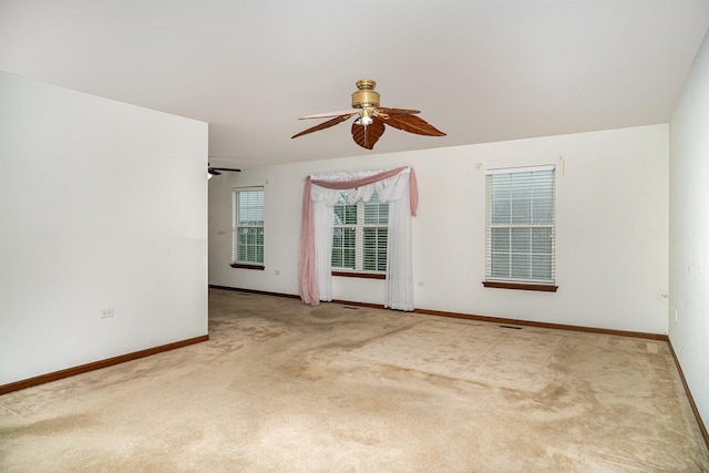 empty room with baseboards, carpet flooring, and a ceiling fan