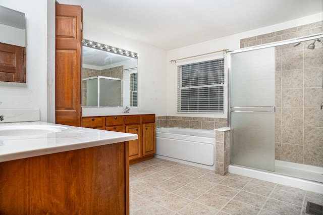 full bath featuring a garden tub, visible vents, a shower stall, two vanities, and a sink